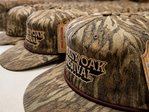 Group of embroidered camouflage caps arranged after production