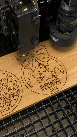 Laser engraving an Impress Designs ornament from wood