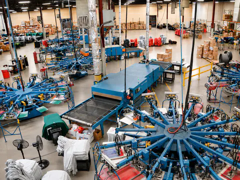 Wide overhead view of the Impress Designs automatic screen-printing floor