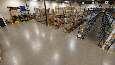 Wide warehouse aisle with organized racks and cartons