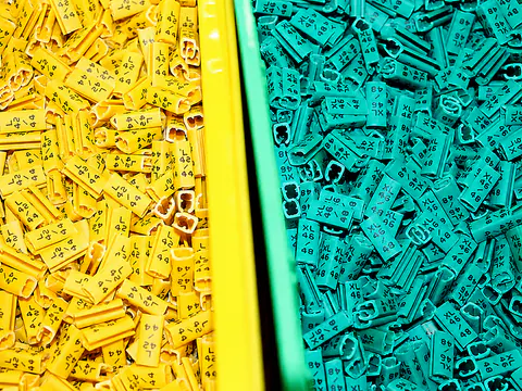 Organized bins holding colored tags and labeling components
