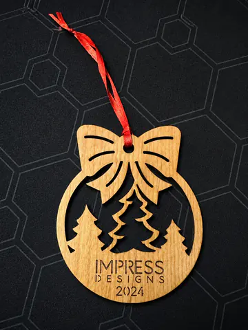 Laser-cut wooden bow ornament displayed after production