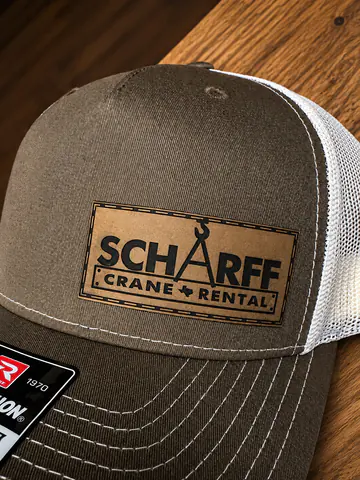 Leather patch applied to the front of a finished cap