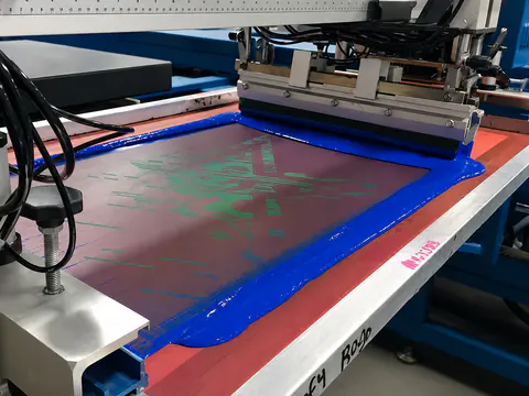 Close view of a screen-printing press during production