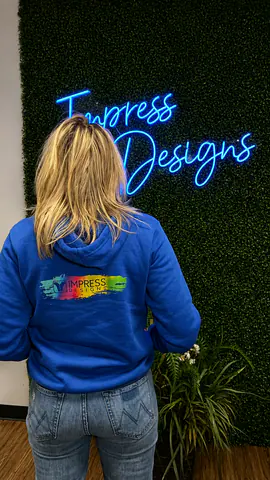 Team member wearing a finished direct-to-film decorated sweatshirt