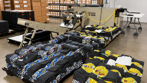 Automatic folding line processing stacks of printed shirts